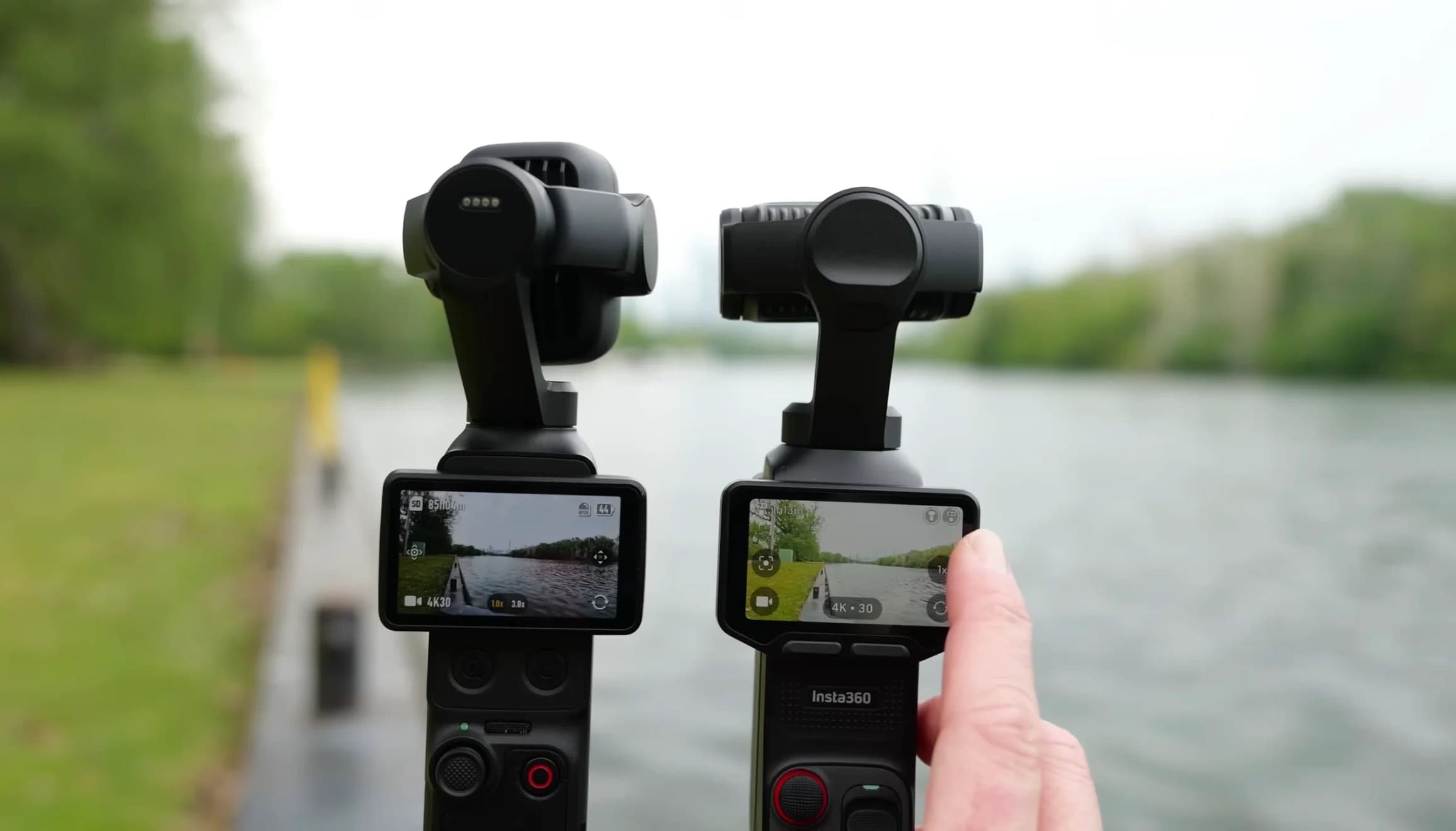 DJI Osmo Pocket och Insta360-kamera sida vid sida vid en sjö.