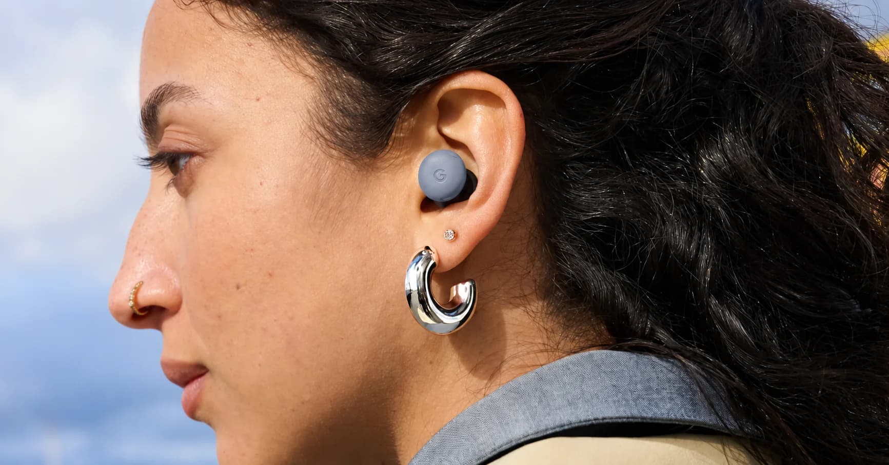 Närbild från sidan av en person med en Google Pixel Buds-hörlur i örat.