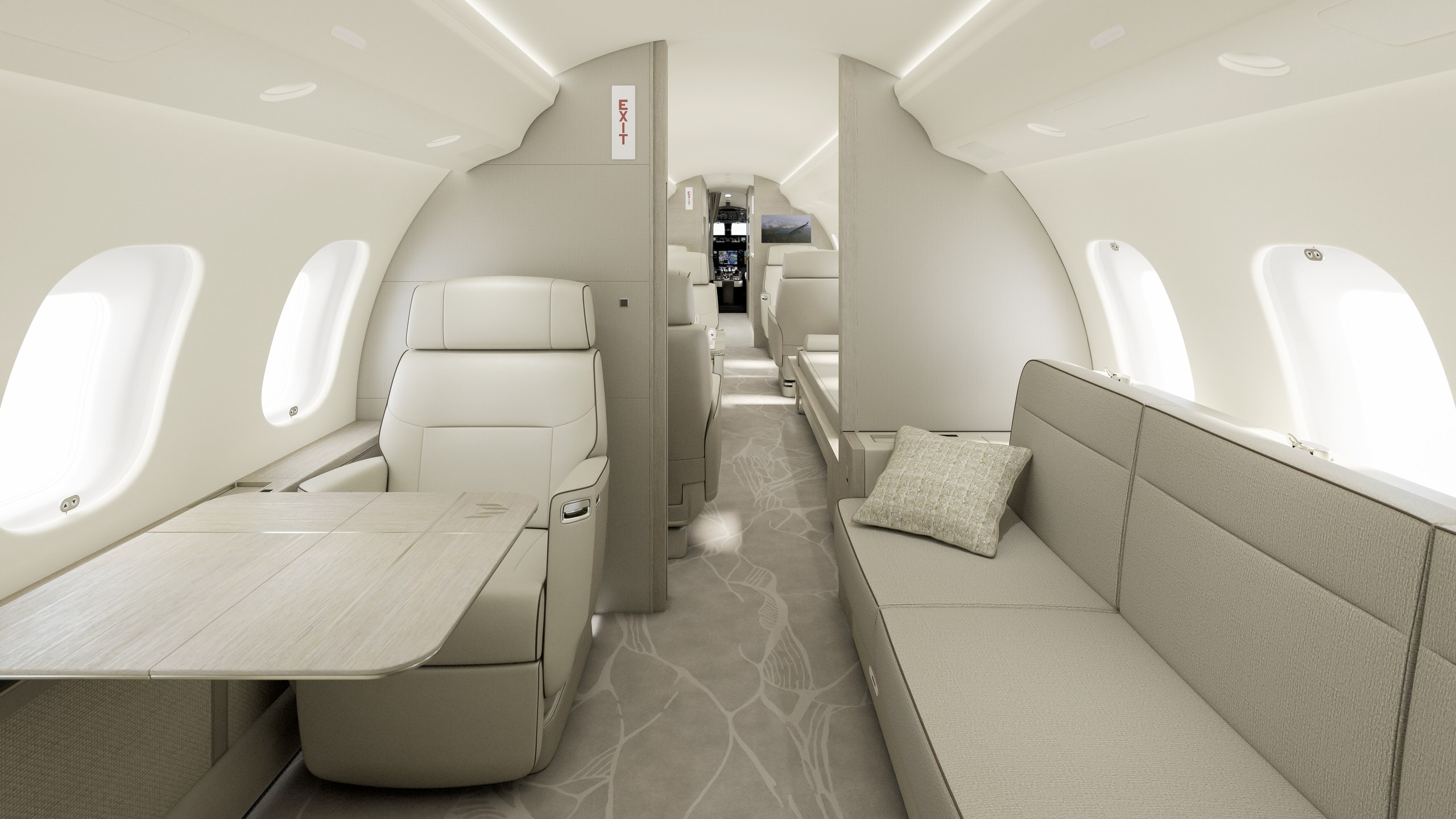 En ljus sittgrupp längre bak i kabinen på en Bombardier Global 6500, med två fåtöljer, bord och soffa.