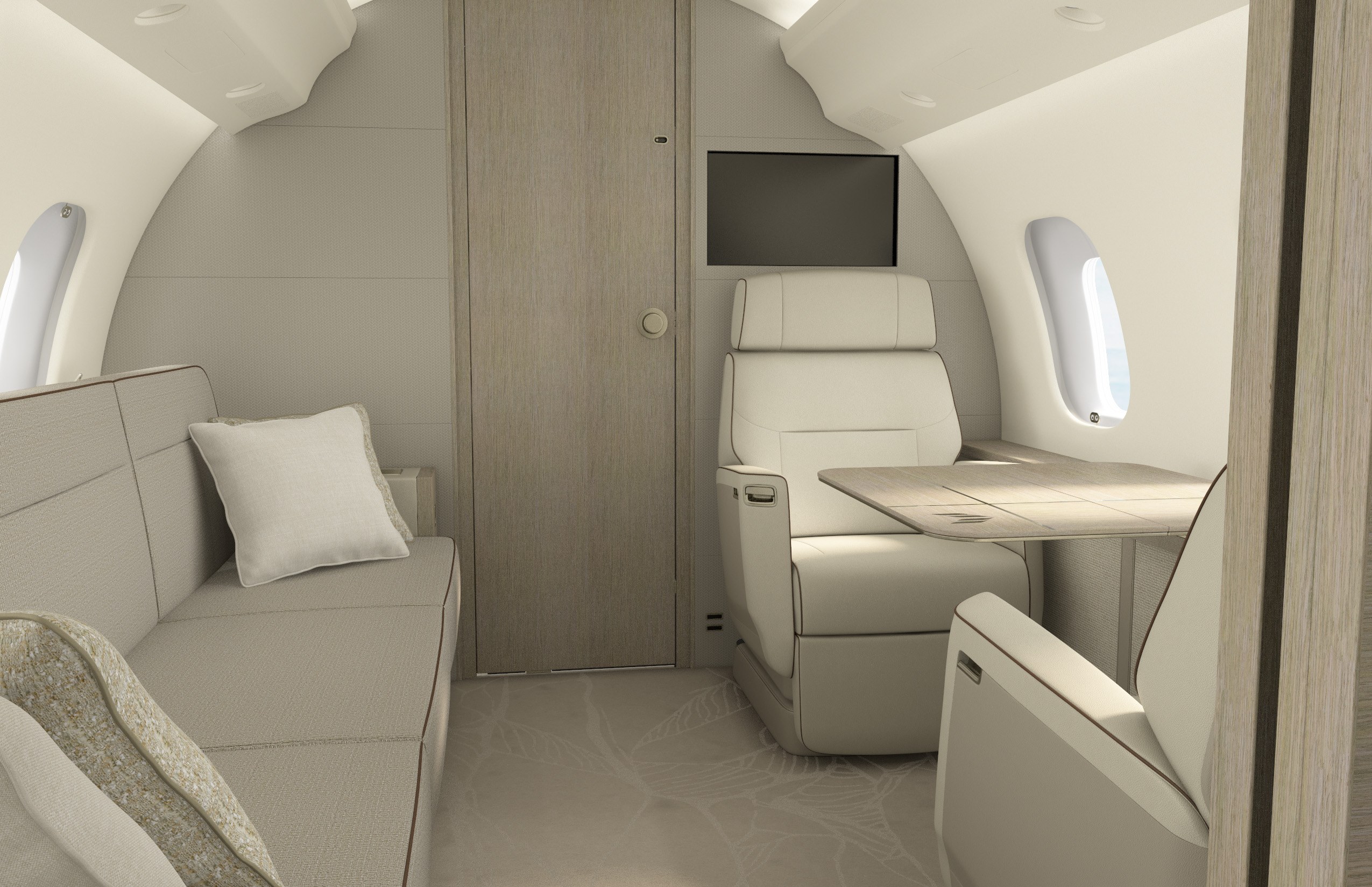 Den främre sittgruppen i en Bombardier Global 6500 med ljusa stolar, soffa, bord och bildskärm.